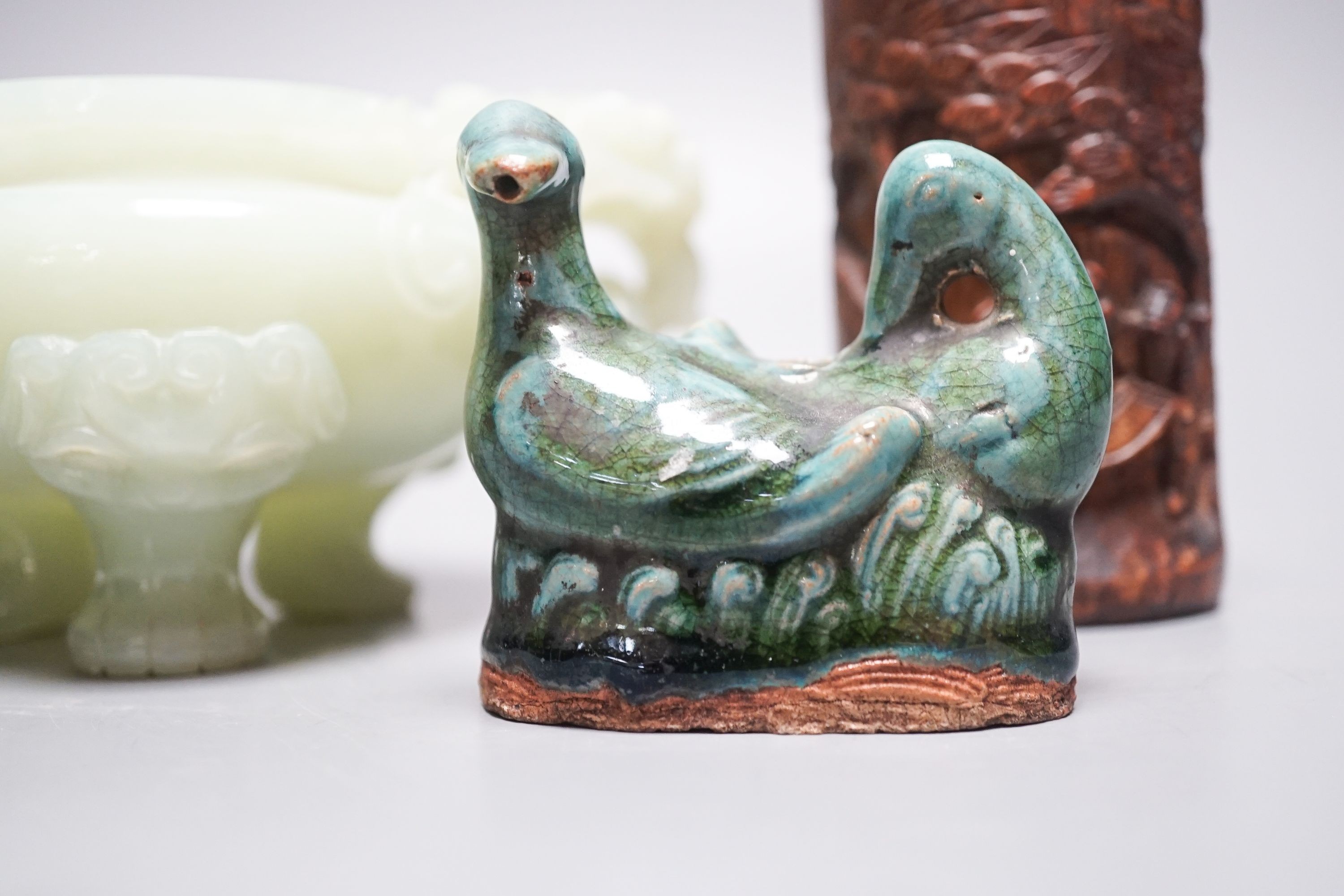 A Chinese bowenite jade tripod censer, 17cm wide, a Chinese green glazed ‘duck’ water dropper and a small bamboo brush part, 19th/20th century (3)